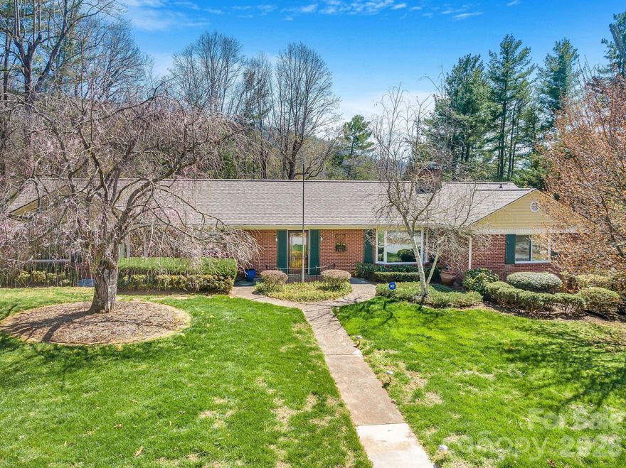 Situated on an idyllic corner lot of over 0.8 acres in the highly desirable Grove Park/Kimberly Heights area of North Asheville, this spacious five-bedroom, four-bath ranch offers more than 3,500 square feet of comfortable living space with generously sized rooms throughout. The home enjoys a wonderful sense of privacy while still being just minutes from the restaurants, shops, and grocery stores of North Asheville and less than 10 minutes to downtown. During the winter months, the property features mountain views along with views of The Grove Park Inn and downtown Asheville. Both the home and grounds have been meticulously maintained, creating a move-in ready opportunity in one of Asheville’s most sought-after neighborhoods. The home also features two working fireplaces, adding warmth and character to the living spaces. Recent updates provide peace of mind, including a brand-new Generac whole-home generator installed just last month, as well as major system improvements within the last five years including the roof, dual heat pumps, and two water heaters. A natural gas line is also already in place at the home. With its generous lot size, spacious layout, and exceptional location, 4 Dogwood Road presents a unique opportunity to enjoy privacy, comfort, and convenience in North Asheville.