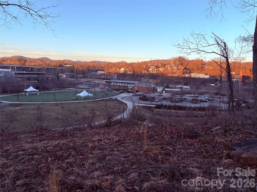 Rare 1/3 acre lot in unbeatable West AVL location, just steps to the River Arts District and New Belgium Brewing! This gently sloping lot provides a perfect setting for a dream home, or could be subdivided into 2 lots (buyer to verify with city planning/zoning office). This lot sits approximately 30 feet above the greenway with easy pedestrian access to all the amenities of the River Arts District, while providing stunning views of the city and mountains ABOVE the flood zone. Furthermore, the already stunning views could be dramatically improved with each sequential story as you build up. Please see Lot F on attached plat; the former dilapidated home has been completely removed by the sellers. Come see a perfect combination of views, convenience, and privacy in a prime West AVL/RAD location!