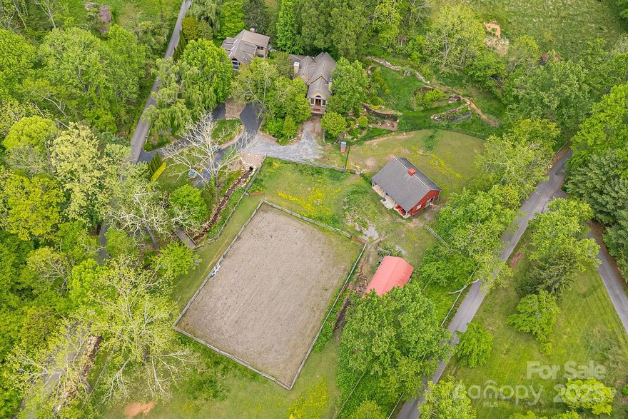 Welcome to your luxury equestrian estate—peaceful, private, and just minutes from downtown Asheville. This rare retreat spans nearly 4 acres and features over 4000 sq ft custom home with 5 spacious bedrooms and 3.5 bathrooms.

Two large living rooms provide plenty of space to relax or entertain. The expansive primary suite is a true sanctuary, with a spa-like en suite adorned in handmade Turkish tile, a private study or office, and access to a Zen patio with a soothing fountain and lush landscaping.

The home was designed & built around *and over the creek, take in the calming sounds from anywhere on the property — whether you're enjoying the screened-in front porch or unwinding in the living room.

Outside, stroll through the rose garden, watch horses graze the open pasture, or visit the well-kept stables. Perfect for equestrian or mini-farm living, this estate offers space to breathe, garden, and enjoy fresh mountain air.

Make 95 Carter Cove your dream mountain estate today!