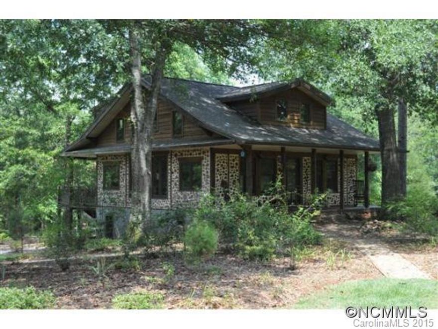 Unique post and beam cabin with cord wood masonry. Open floor plan, with wood stove in the living room. Eat in Kitchen with movable island that doubles as a table. Most bedrooms irregular in size and are on the second level, including a small office and are accessed by spiral staircase. Screened back porch, covered deck, mini pool. Wonderful setting, stream, private trails meander throughout the property. Storage/shop building with overhangs.