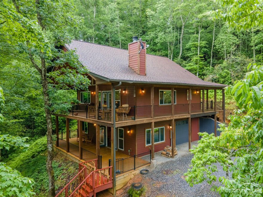 The perfect mountain getaway awaits you. Nestled on 3 unrestricted acres and surrounded by nature, experience the perfect blend of rustic charm and modern comforts in this 2 bed/2 bath retreat. Step inside the open floor plan and be captivated by the timeless beauty of tongue & groove pine walls and ceilings, a cozy wood-burning fireplace, and reclaimed wood used throughout the cabin sourced directly from the property. Sneak away to the loft or lower level sitting room for extra living/sleeping space to accommodate extra guest. Step out onto the expansive porch, offering over 900 sq ft of outdoor living space for relaxation or entertainment; there's a place for everyone. PANORAMIC winter view. Open up the view to enjoy the beauty of all seasons or keep tucked away amongst the trees. Located just 15 minutes away from Bryson City, Sylva, and Harrah's Cherokee Casino, you'll have easy access to all major conveniences while enjoying the seclusion and privacy of your cabin oasis.