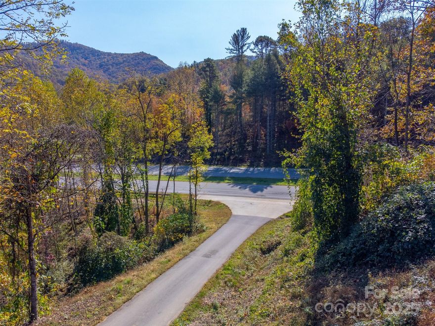 Looking for a multi-use property? This one is conveniently located outside the city limits of both Sylva and Franklin and on one of the busiest roads in WNC. Offering 8 acres with a 4000 sq. ft. metal building with 2 Drive In Grade level bays, a large business office, managers office, kitchen area and flex space with bathroom. But that's not all. Also included are 18.52 acres to build a couple of dream homes on with mountain views and trails for hiking. This property has lots of parking area for a large fleet of vehicles or parking space for a venue. This is the one you've been looking for.