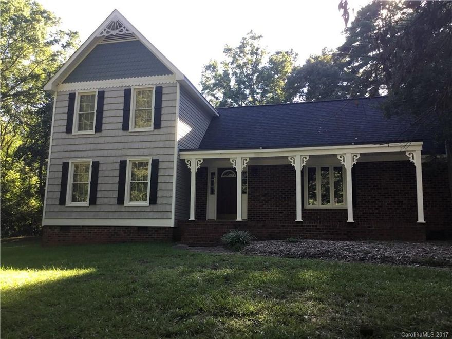 Perfect fixer-upper opportunity conveniently located minutes away from Uptown Charlotte! Custom built home on an acre of land. Replica from a farm house from Better Homes and Garden in the 70's. Oversized two car garage with second living qtrs above with kitchenette and full bath. Beams in the two story great room with brick fireplace gives you that country living vibe. Master with wrought iron staircase for entry. Sunroom provides great space for entertaining or relaxing. Endless opportunities!