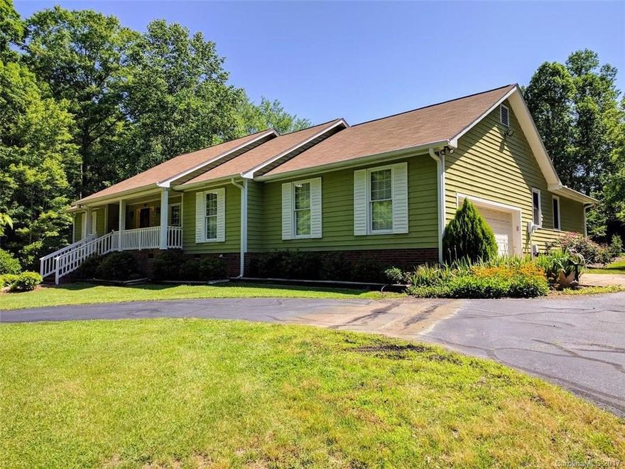 Ranch home.. almost three and a half acres.. rocking chair front porch.. wood laminate flooring throughout.. granite countertops... dual marble vanity in the master... split bedroom plan.. sunroom.. no, it's not a joke! Come see it for yourself! It's truly one of a kind!!