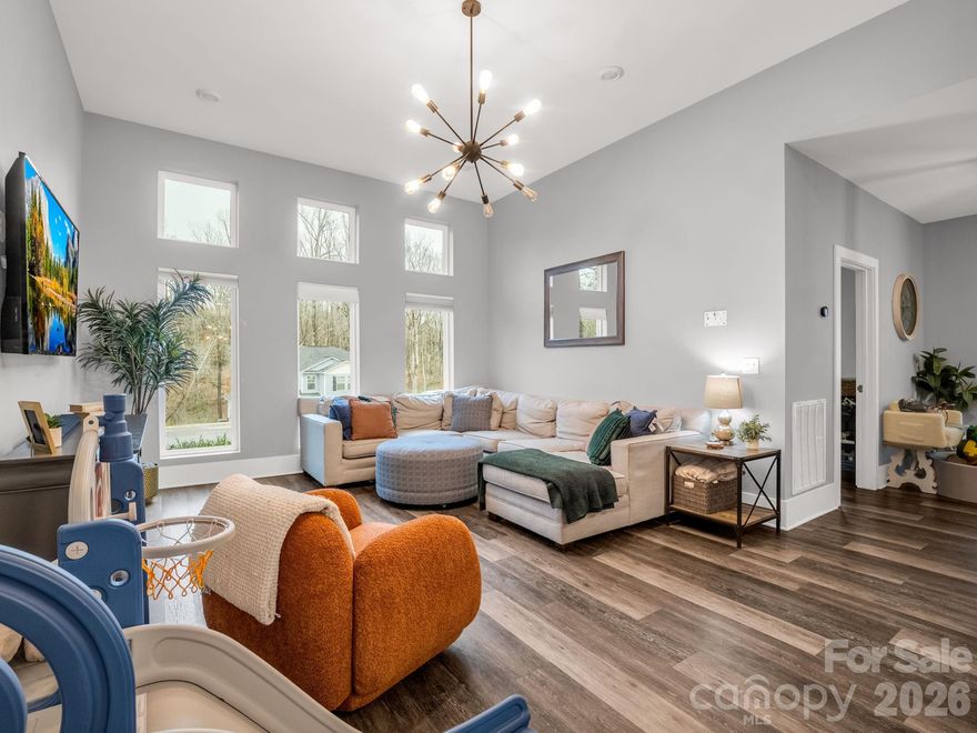 This beautifully crafted 3-bedroom, 2-bath contemporary home is a must-see! Situated on a desirable corner lot in the neighborhood, this over 1,700 sq ft home offers a split-bedroom floor plan with 9–12 ft ceilings, custom vinyl flooring, and designer window shades throughout.  The open-concept layout is perfect for entertaining, featuring a stunning kitchen with custom cabinetry, soft-close cabinets, granite countertops, stainless steel WiFi-enabled appliances, a pantry/laundry combo, and a dedicated coffee bar. The spacious primary suite offers a luxurious retreat with dual vanities, granite countertops, a custom-tiled walk-in shower, and separate his-and-her closets.
Enjoy outdoor living on the custom Trex deck, complete with a privacy fence. Additional features include a fully finished two-car garage and an extra-wide concrete driveway. Move-in ready with modern upgrades throughout—this home truly has it all!