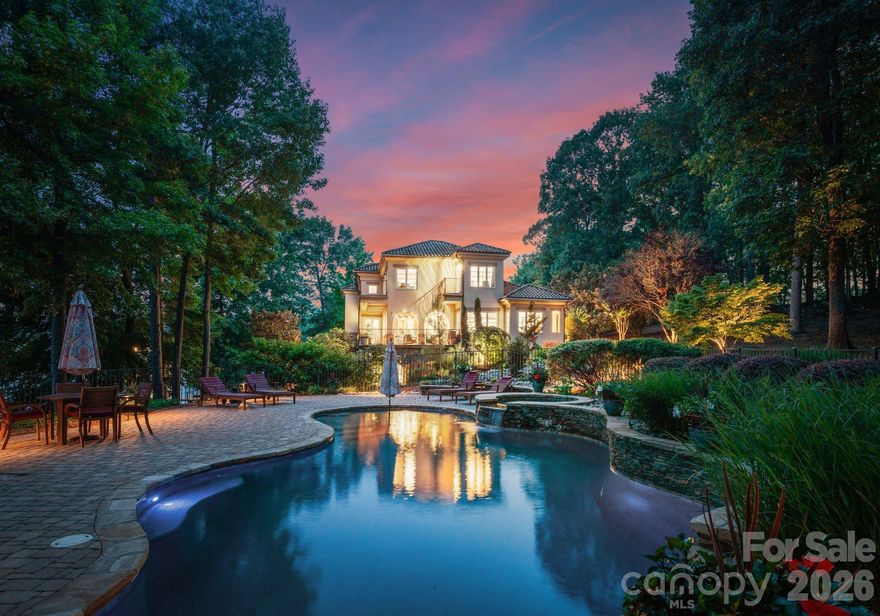 Presenting a rare opportunity to own a magnificent 4-acre waterfront estate on the main channel of Lake Norman. With an impressive 1,200 feet of shoreline, this Mediterranean-style residence offers unparalleled privacy and panoramic water views. The meticulously landscaped grounds feature a luxurious spa pool with a hot tub, a private sandy beach, a premium floating dock, and a serene Japanese garden complete with a waterfall—creating a resort-like oasis perfect for both grand-scale entertaining and tranquil escapes or yoga retreat.
Inside, the home's grandeur is immediately apparent with a soaring two-story stone fireplace that serves as the focal point of the sun-drenched great room. The open-concept floor plan is thoughtfully designed for modern living, with arched entries and expansive windows framing the stunning lake vistas. A chef's kitchen, equipped with granite countertops,  stainless steel appliances, and a butler's pantry, flows seamlessly into the dining and living areas.
The main level primary suite is a true retreat, with lavish bathroom with both indoor and outdoor showers, a jetted tub, and dual vanities. The upper level offers a versatile loft space, ideal for a playroom or billiards room, along with two generously sized bedrooms, each with its own terrace overlooking the lake and pool. The fully finished walk-out basement provides additional living and entertaining space, including a media room, recreation area, and two private guest suites.
This exceptional property, complete with a distinctive bell tower and a three-car garage, is conveniently located just minutes from shopping, dining, and major highways for easy airport access. Experience the pinnacle of luxury lakefront living in this one-of-a-kind Lake Norman estate