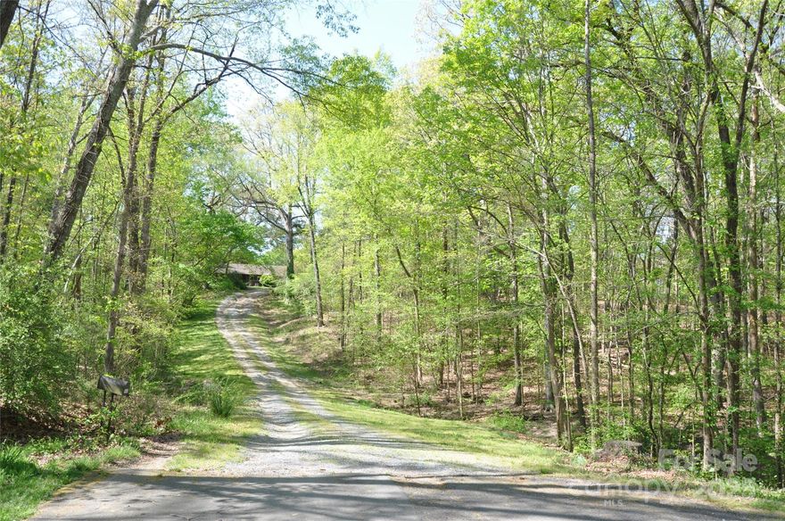 Discover a unique opportunity to own 5.19 beautiful, wooded acres in Matthews, NC. Nestled in a peaceful setting, this expansive property offers privacy, natural beauty, and convenience—perfect for building your dream home or exploring development potential.  Located just minutes from the Arbouretum and downtown Matthews, shopping, dining, schools, and major highways, this property offers the best of both worlds: secluded living with urban convenience.

House and outbuildings are sold as is/ where is and have no value in the transaction.