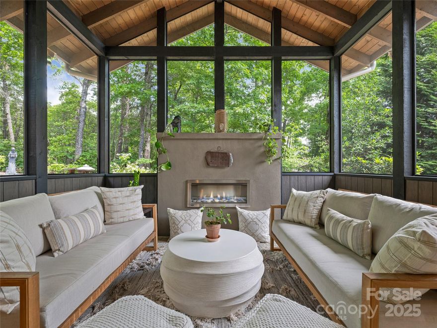 Located in the gated community of Southcliff, this stunning custom home, by Living Stone Design + Build, offers refined mountain living just minutes from downtown Asheville. Thoughtfully designed for comfort and functionality, the main level features a spacious primary suite, a home office, a gourmet kitchen with a gas cooktop, a large kitchen island, and a walk-in pantry.  The open floor plan flows into a screened porch and private outdoor spaces. 
Spacious laundry room with cleaning sink, lots of storage, and a large two-car garage with no steps to enter the home. Upstairs, discover two bedrooms, a full bath, a bright 17x21 flex space, and a beautiful enclosed sunroom/office. Enjoy stunning landscaping from this private cul-de-sac lot, surrounded by lush woods and bordered by walking trails. Southcliff amenities include parks, playgrounds, pavilion, and over 6 miles of hiking trails, 24/7 Security—modern mountain living at its finest—move-in ready and meticulously maintained.