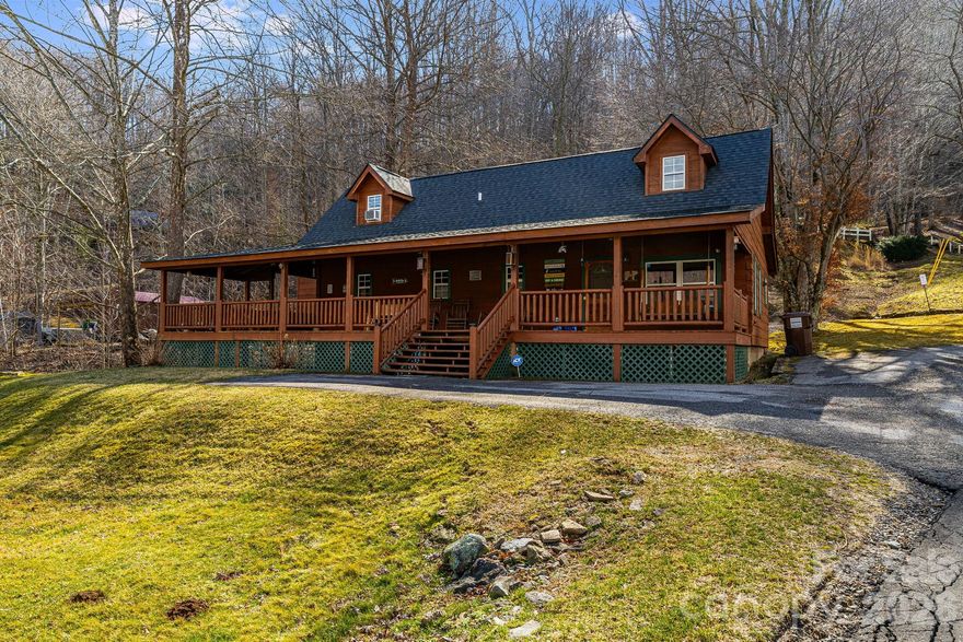 Experience panoramic mountain views from this custom-built Maggie Valley cabin ideally positioned in the heart of the Smokies. Designed for year-round enjoyment, the home features an expansive wraparound porch complete with a large hot tub, double porch swing, rocking chairs, covered dining space, and gas grill—all oriented to capture the surrounding scenery. Inside, the open living area offers a welcoming fireplace, abundant seating, and a fully equipped kitchen suited for extended stays. Conveniently located just minutes from Cataloochee Ski Area, Soco Falls, the Blue Ridge Parkway, Waynesville, and Cherokee, the property provides easy access to skiing, hiking, gaming, and seasonal festivals, while Asheville and Gatlinburg are within comfortable driving distance. With no 4WD required for access and strong four-season tourism in Maggie Valley, this fully turnkey cabin presents an excellent opportunity as a high-performing short-term rental or mountain getaway.