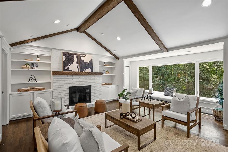 Character meets modern design in the heart of Davidson. This expansive, private wooded lot features trails woven throughout the backyard. Experience one-level living with a full basement, including a second kitchen ideal for additional living quarters. The stunning double-door entry opens into an oversized dining room, perfect for entertaining. Open living space boasts vaulted ceiling, exposed beams, a wood-burning fireplace, and extended picture windows. Fully remodeled kitchen highlights an oversized island, Mercury gas range, SubZero refrigerator, and numerous thoughtful design features. Enjoy a dedicated office space with showcasing built-ins. Additional features include an extended custom drop zone, renovated laundry room, updated powder room, and ample pantry space. Large storage areas in basement and exterior entry. Downtown Davidson offers small-town charm with shops, restaurants, festivals, concerts, and a variety of seasonal activities.