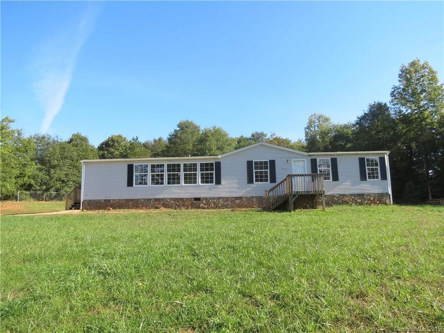 Spacious home in the country.  Large living room with rock fireplace.  Kitchen has island, lots of cabinets and beautiful windows for natural light.  Master bedroom has walk-in closet, garden tub and dual sink vanity.  Sliding door to back deck.  New carpet throughout.  Large 3/4 acre lot with private back yard.  Why rent when you can own for less?