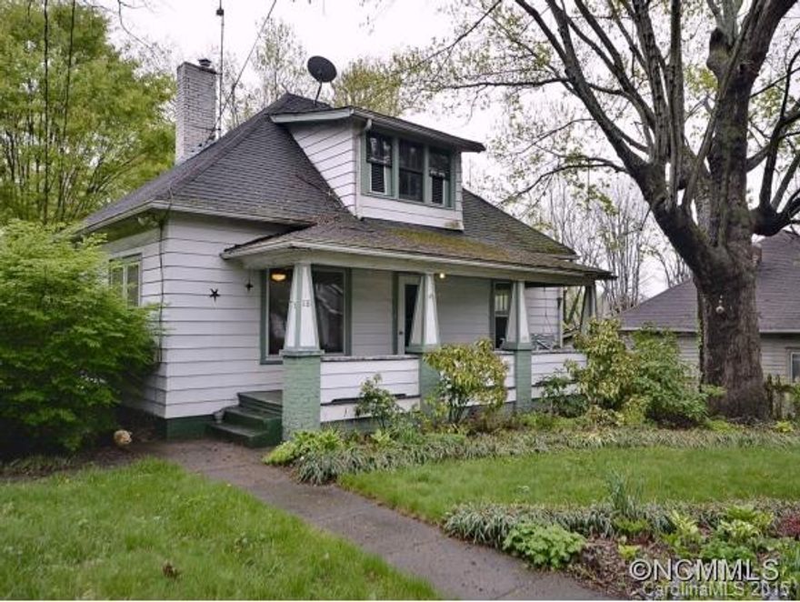 Classic 1920s West Asheville bungalow with traditional bungalow floor plan, hardwood floors, covered front porch and rear deck. Plenty of character. Potential for expansion with walk-up attic space. Full unfinished walk out basement ideal for workshop. Fantastic, level .55 double lot, fully fenced, and garden space. Two driveways, one on each side of the house. According to Buncombe Planning & Zoning lot can be subdivided.