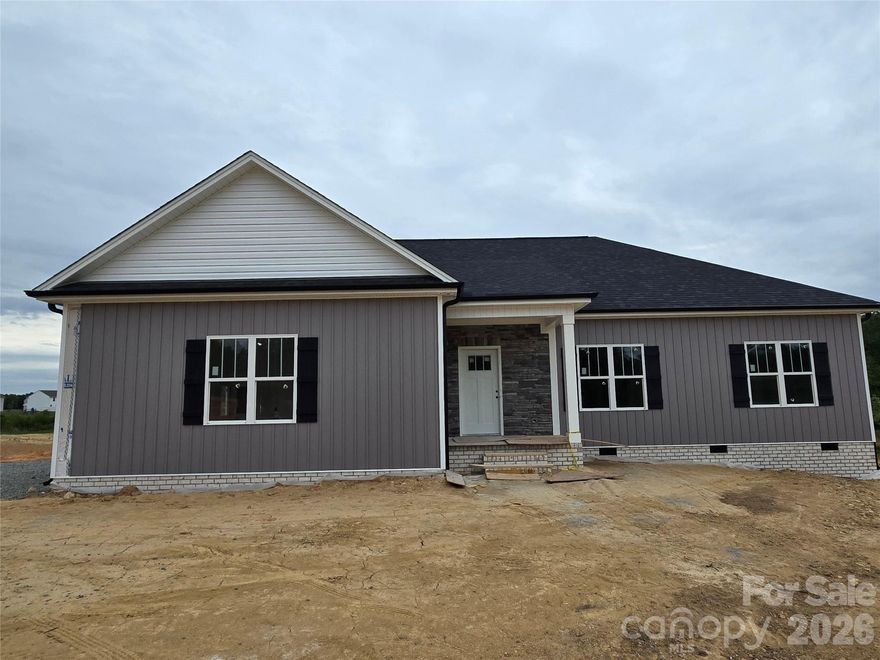 Stunning New Construction in Northern Davidson County on almost 6 Acres... One level Living .. Vinyl Board & Batten Siding & Stone Accents...Take notice of all the custom details! Covered Front Entry, Beautiful Hardwood Floors throughout Living Room, Kitchen, Dining and All Bedrooms ... Vaulted Living Room Ceilings & Stone Accented Gas (propane) Fireplace ..Kitchen offers green cabinets with natural island, stainless appliances, Quartz & Granite Countertops, Tile Backsplash, Island with Bar Seating ...Laundry Room w Storage Cabinets... Tile Flooring in Bathrooms & Laundry Room...Recess lighting throughout... Primary BR w tray ceiling, Walk-in Closet... Primary Bath with Double Vanity, Expansive, Beautiful Walk-in Tiled Shower w recessed shower niche and corner seat... Step out back to embrace your Covered Back Porch and take in the view of your land .. 2 Car Attached Garage with Entry Door ... Photos will be updated as progress continues, See Agent Only for Preferred Lender Incentives, (portion of land by creek - not the home - is in a flood zone) PLAT UNDER ATTACHMENTS