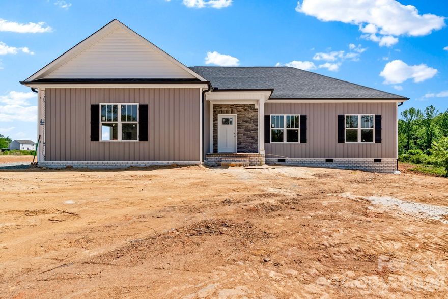 Stunning New Construction in Northern Davidson County on almost 6 Acres... One level Living .. Vinyl Board & Batten Siding & Stone Accents...Take notice of all the custom details! Covered Front Entry, Beautiful Hardwood Floors throughout Living Room, Kitchen, Dining and All Bedrooms ... Vaulted Living Room Ceilings & Stone Accented Gas (propane) Fireplace ..Kitchen offers green cabinets with natural island, stainless appliances, Quartz & Granite Countertops, Tile Backsplash, Island with Bar Seating ...Laundry Room w Storage Cabinets... Tile Flooring in Bathrooms & Laundry Room...Recess lighting throughout... Primary BR w tray ceiling, Walk-in Closet... Primary Bath with Double Vanity, Expansive, Beautiful Walk-in Tiled Shower w recessed shower niche and corner seat... Step out back to embrace your Covered Back Porch and take in the view of your land .. 2 Car Attached Garage with Entry Door ... Interior Photos are similar to this home - Estimated Completion mid June... Preferred Lender Incentives -- See Agent Only for additional information (portion of land by creek - not the home - is in a flood zone) PLAT UNDER ATTACHMENTS