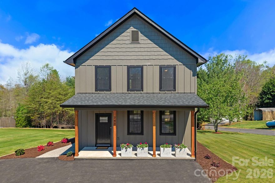 Stunning new construction just minutes from Downtown Asheville, showcasing cutting-edge modern finishes, clean architectural lines, and a design that feels both current and elevated.

The main level is centered around a vast open floor plan filled with natural light, creating a seamless connection between the living, dining, and kitchen spaces. Every detail has been thoughtfully selected, from the curated finishes to the intentional layout that enhances both style and livability.

The kitchen stands out with custom cabinetry, granite countertops, stainless steel appliances, and a spacious island designed for gathering and entertaining. The adjoining living area is anchored by custom built-ins, adding both character and function.

Attention to detail continues in the mudroom, where custom built-ins and a granite bench create a refined and practical drop zone just off the main living space.

Upstairs, the primary suite offers a well-designed retreat with a double vanity, modern fixtures, and a beautifully finished tiled shower. A spacious walk-in closet with custom shelving provides excellent storage and organization. Additional bedrooms are bright and versatile, offering flexibility for guests, work-from-home needs, or everyday living.

Outdoor spaces are equally inviting, with a covered front porch featuring warm wood accents and a back deck ideal for relaxing or entertaining.

Located less than 15 minutes from Downtown Asheville and the River Arts District, this home delivers a rare combination of modern design, thoughtful detail, and convenient access to everything Asheville has to offer.