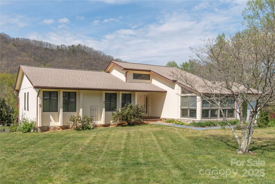 Breathtaking long-range mountain views await in this beautiful home in downtown Maggie Valley! Situated on a large open lot with tranquil surroundings, this property is perfect as a vacation home, retreat, or year-round residence. Enjoy peaceful mornings and vibrant evenings on the recently added covered deck—ideal for relaxing or entertaining in Spring, Summer, and Fall. The main level offers easy living with a primary suite, kitchen, laundry, two guest bedrooms, and a guest bath. The basement features a full bath, garage, and exterior access—ready to be customized to fit your needs. All furnishings may convey with home. Magnificent location!!! A rare mountain gem!