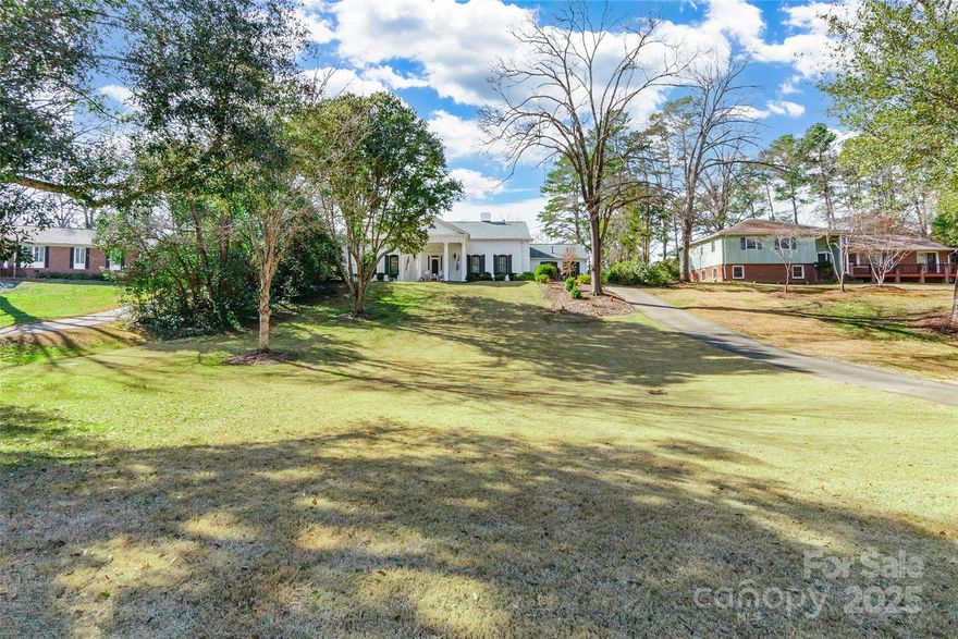 This stunning 4 BD, 3.5 BA home seamlessly blends timeless charm with modern updates. A covered front porch invites you into a home featuring refinished hardwood floors throughout. The renovated kitchen, while retaining some original details, showcases quartz countertops, a farmhouse sink, a gorgeous backsplash, a coffee/wine bar with a beverage refrigerator, and a window overlooking the screened porch. Enjoy 2 fireplaces—one in the den & another in the living room. The main-level primary bedroom boasts a show-stopping bathroom with an oversized shower with dual shower heads, a clawfoot tub & marble floors. Upstairs, you'll find 3 spacious bedrooms—one with a dedicated full bathroom and two connected by a Jack & Jill bath. Plantation shutters, newer HVAC units, and an encapsulated crawl space add comfort & efficiency. The backyard is a dream, featuring a screened porch, paver patio, firepit, fenced pool and a covered poolside lounge with electrical hookups. Get ready to fall in love!