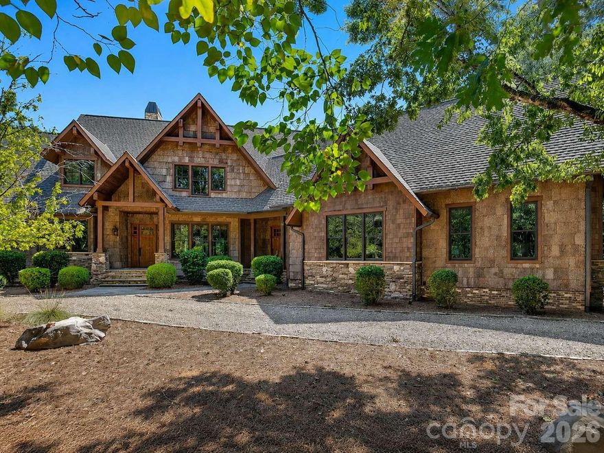 Nestled within 2.27 wooded acres in The Sanctuary on Lake Wylie, this one-of-a-kind luxury retreat blends exceptional craftsmanship, rustic elegance, sustainable design, and immediate investment potential.

Thoughtfully curated with rare and enduring materials, the home features authentic MAINTENANCE-FREE Poplar Bark siding with a 75+ year lifespan, reclaimed barn wood accents, stone tile, engineered hardwood flooring, solid walnut cabinetry, a tankless water heater, and a greenhouse designed for year-round cultivation—each selected for lasting beauty, sustainability, and performance.

At the heart of the home, an AGA Legacy range anchors a chef-inspired kitchen complemented by rich architectural detailing and bespoke finishes throughout.

Outdoor living is equally intentional, with a saltwater pool nestled within the wooded landscape, creating a private retreat immersed in nature.

Offering approximately 3,653 finished square feet, the residence was designed with future flexibility in mind. An unfinished 4th bedroom with en suite bath and a separate bonus room with full bath—both already plumbed and wired—provide a seamless opportunity for expansion. If completed, the home would encompass approximately 4 bedrooms, 5.5 baths, and a bonus room, adding roughly 1,030 square feet of additional living space and presenting instant equity upon completion.