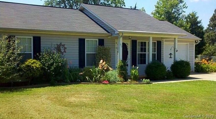 Looking for a country setting that is still within a reasonable travel distance to town & interstate? Check out this nicely updated 3 bedroom home!  3rd bedroom currently used as a large walk in closet, which might appeal to a new buyer as well. Storage shed, low maintenance vinyl, back patio to enjoy the long range views of nature & NO HOA fees! Great starter home w/laminate wood flooring, tile backsplash, cherry look kitchen cabinetry & W/D currently in garage, but stack unit can go inside.