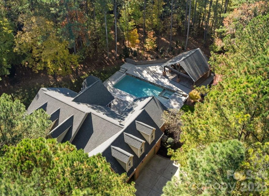 Estate Living at Its Finest in Valhalla Farms.  Set on 2.38 private acres, this stunning 4-bedroom estate has been transformed with $600K+ in luxury additions & upgrades.  Resort-style living awaits with a heated saltwater pool, attached spa, sheer waterfalls, tanning ledge, electric cover—and a show-stopping pool house featuring a half bath, storage, fireplace, full outdoor kitchen, and bar.  Inside, enjoy quartz kitchen upgrades, new baths, custom closets, fresh paint, new LVP flooring, designer window treatments, and so much more. Outdoor highlights include Tec decking, landscape lighting, irrigation, and lush landscaping.  Nestled in a beautiful wooded community with a pond & walking trails, plus optional pool & tennis membership.  Much of the interior repainted in 2025. Beautiful wooded community with pond and walking path. Community pool and tennis membership available at waxhawpool.com. The main house has three full bathrooms and two half bathrooms, but there is also a half bathroom in the poolhouse for a total of three half baths. "Additional square footage" is half bath and storage room in detached pool house.