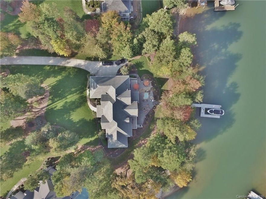 Stunning all brick home with pristine landscape on a picturesque cove.  Home is an entertainer's dream with an open layout and lake level basement with bar, wine cellar & theater room. This home will charm you immediately with its keenly designed layout featuring a lakefront office & secondary bedrooms each with private bath. Truly enjoy lakefront living with cozy screened-in porch, terrace off master suite & sprawling patio with outdoor kitchen, gas fire pit & waterfall spa.