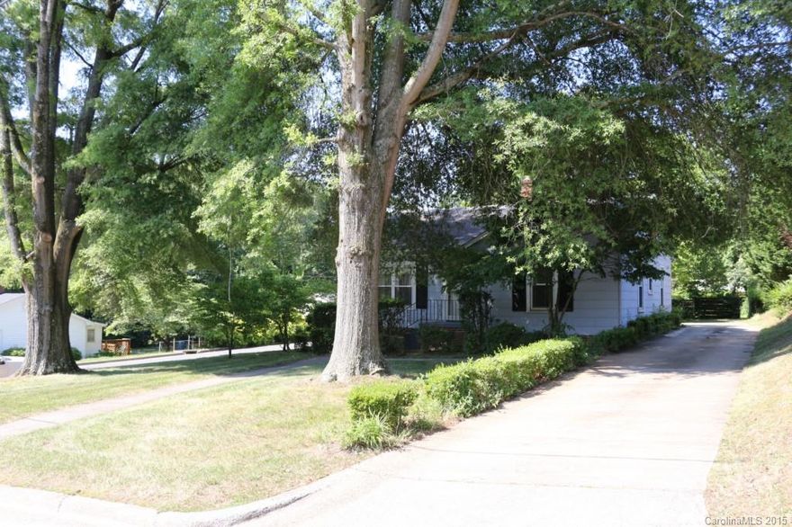Beautiful huge trees offer a canopy of shade.  Refinished wood floors, lots of closets. Front & back porches.  Back porch freshly painted & repaired. Lots of sprucing up inside has been done. Cedar lined closet. Seller states hardwoods under carpet in LR. Pull down stairs to nice floored attic. Convenient location, close to town shopping, etc.