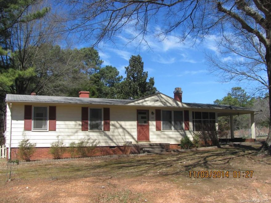 Nice home on double lot. Fireplace and hard wood floors in living area, storage room. Fenced back yard, detached storage, screened porch and a two car carport.  REDUCED!