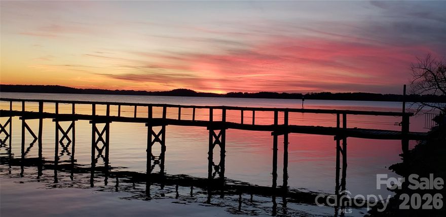 Large, (.856 acre) gently sloping waterfront corner lot at end of peninsula with 50' of water frontage, deep water, covered pier, boat lift, and small sandy beach. Water views in all directions, with sunrise (seasonal) and sunset views. Eleven zone irrigation system. 3 BR 2 bath house is likely a teardown, but could be remodeled if desired. It features a large LR, large rec room with 12' bar, sink/ wet bar, sunroom facing lake, deck facing lake, patio, and covered hot tub area. Ramsey Creek Park is within this community and has a dog park, boat ramp, docks, beach, picnic areas, playground, and walking trails. Located off Catawba Ave in Cornelius between I-77 exits 25 & 28. Abundant shopping, dining, and recreational activities are all close by.

Seller/owner is a licensed real estate agent. Lot can be viewed by appointment with seller. House viewing requires advance notice and proof of funds.