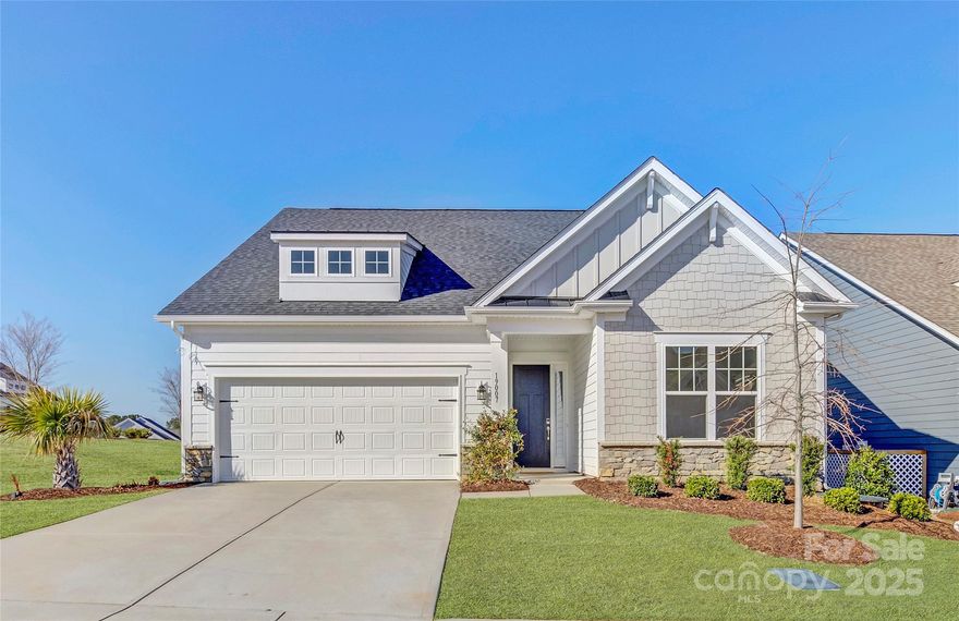 Immaculate 1 1/2 story home in the desirable North Reach neighborhood. The guest bedroom and hall bath are located toward the front of the home. The heart of the home presents the gourmet kitchen offering an oversized prep island with farmhouse sink, ample storage space, and room for seating. A gas cooktop is paired with a wall oven and a microwave. Pendant & recessed lighting highlight the ample white cabinets. Breakfast & great room are flooded with natural light & beautiful hardwoods unite the main floor living spaces. A chandelier highlights the tray ceiling in the primary suite & a spa-like bath is luxurious. Upstairs, the loft is a great entertainment/office/hobby space & additional bedroom & full bath, perfect for guests. A lovely deck sits just off the breakfast area & the outdoor living space is extended by a paver patio, perfect for enjoying our fantastic Carolina weather. Social membership to Palisades country club is included in HOA! Lawn maintenance inckuded in HOA