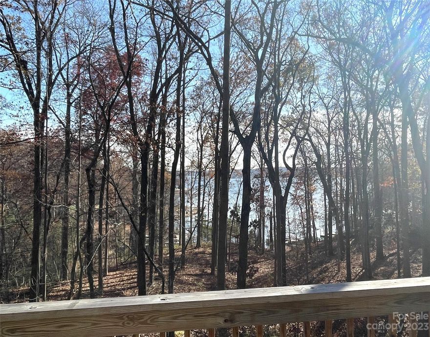 Lovely water views from this charming Sherrills Ford home located on a private lot. Conveys with deeded access to Lake Norman through a nearby waterfront lot. Quiet and serene, yet conveniently located just minutes to shopping and dining. First time on the market, this home is a must see. Kitchen has Samsung stainless steel appliances (new 11/2020) and a large, walk-in pantry. Living room has built-in shelving and a fireplace. Large primary suite on second level with private deck, ensuite and large walk-in closet. Second floor laundry. Dual-zone HVAC units recently replaced (upstairs in 2022; main level in 2018). Newer roof with architectural shingles and 6” seamless gutter system with stainless steel micro mesh gutter guards (installed 11/2020). Make sure to check out the large unfinished, walk-out basement which offers great storage now and a long-term value-add opportunity.