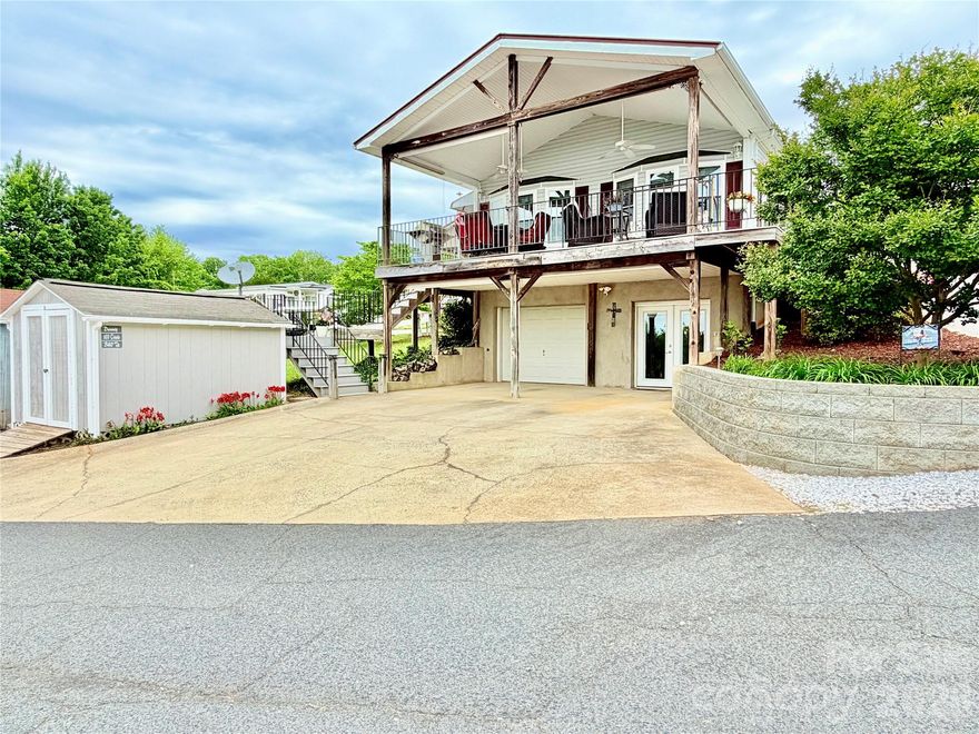 Enjoy wonderful long-range water views of Badin Lake from your spacious covered porch. This 3-bedroom, 2-bath home is located inside the gated waterfront community of Badin Shores Resort and is ideal for full-time living or the perfect lake escape. The main level features an open-concept living and kitchen area along with two bedrooms and one full bath. The updated kitchen offers custom cabinetry with soft-close drawers and pull-out shelving, granite countertops, tile backsplash, and a charming farmhouse-style sink. The main-level bath has also been updated with custom cabinetry and quartz countertops. The lower level features an additional bedroom and full bath, along with a versatile flex room ideal for a home office, hobby space, TV room, or additional sleeping area. You’ll also find a large custom-designed closet appointed with built-in shelving and drawers. A rare find within the community, this property also offers a garage—perfect for a golf cart, side-by-side, or workshop.