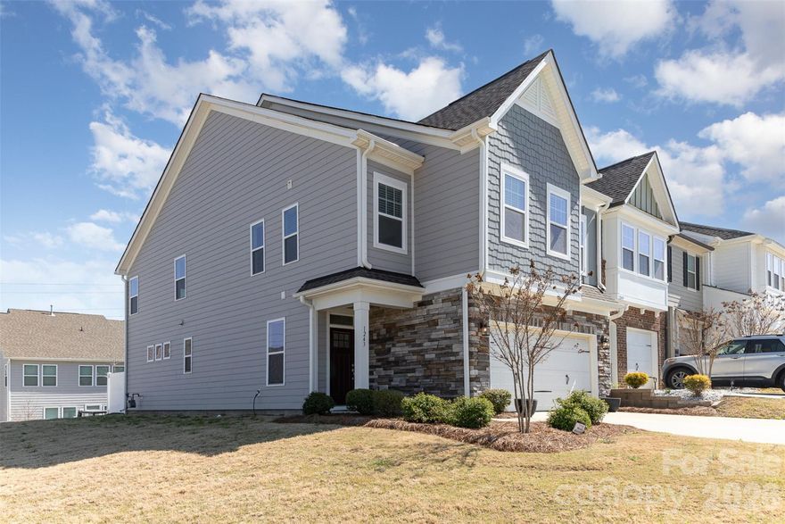 Move in ready end-unit townhome in the sought-after Paddlers Cove community! This light-filled home offers an open, airy floor plan and a well appointed kitchen featuring stainless steel appliances, granite countertops, a tile backsplash, gas cooktop, and an oversized island with custom leg detailing and plenty of seating—perfect for gathering and entertaining. The spacious living area offers a cozy gas fireplace, while the guest bathroom includes a dual-sink vanity for added comfort and functionality. Step outside to your private, partially fenced back patio—perfect for relaxing or entertaining. As an end unit, enjoy extra natural light and enhanced privacy. Residents of Paddlers Cove enjoy access to a community pool, open-air pavilion, and scenic walking, hiking, and biking trails. Conveniently located near Lake Wylie and an easy commute to Charlotte, this home is also zoned for top-rated Clover schools. With stylish finishes and a functional layout, this townhome perfectly blends comfort, convenience, and location.