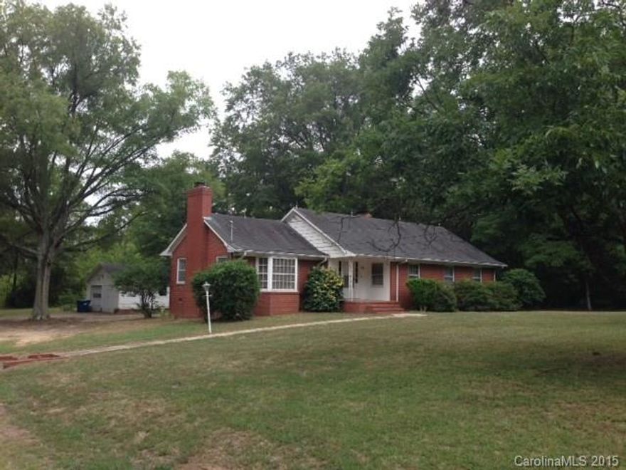 Large living room with fireplace, entrance hall, dining room, knotty pine kitchen- den with fireplace, 3 bedrooms with 2 full baths, basement with ground level windows and door to outside with steps to ground level, fixed attic stairs off the kitchen, covered front porch, enclosed rear patio, detached garage, on +/-4.2 acres.
Convenient to Concord restaurants, malls and hospitals. +/- 1 mile to exit 58 on I-85 and +/-2 miles to exit 60 on I-85, +/-1.5 miles to Concord mall and Northeast Medical