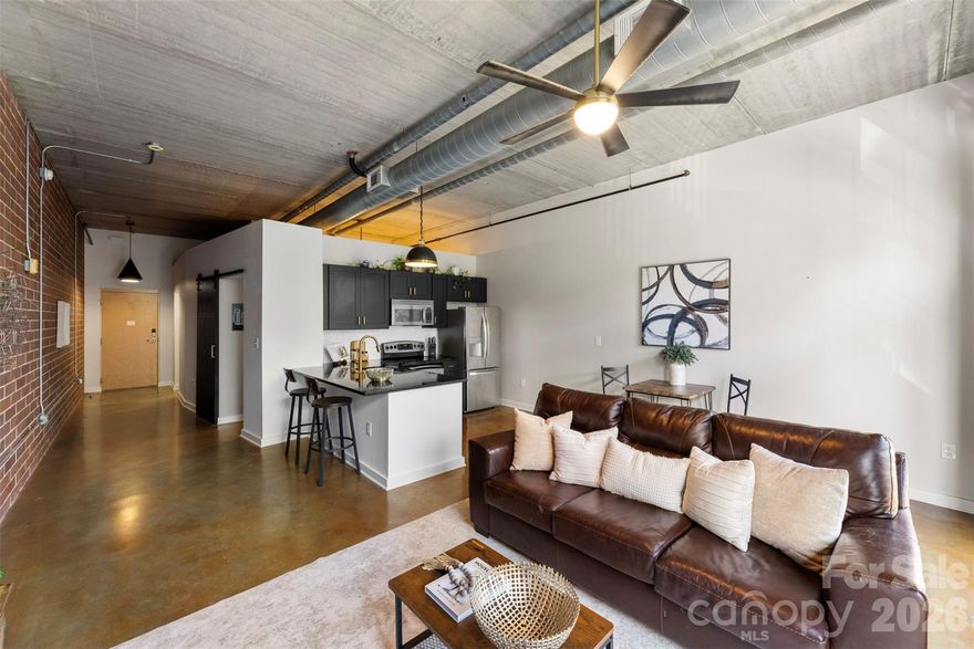 The 626 North Graham building is friendly to both SHORT & LONG TERM RENTALS! Experience the charm of Uptown's historic Fourth Ward in this beautiful condo renovated in 2025! This move-in ready 1-bed, 1-bath unit features fresh paint, high-end light fixtures, and countless updates. Situated on the 2nd floor, it offers views of Uptown and showcases sleek industrial elements like an open floor plan, concrete floors, brick walls, exposed ductwork, floor-to-ceiling windows, and 11-foot ceilings.

The kitchen boasts new wood soft close cabinetry, granite countertops, a white herringbone backsplash, and gold fixtures, complete with a LG fridge (2025) and 7-ft peninsula for counter seating. The full bathroom has been tastefully renovated with white tile, convenient shampoo niches, and a spacious new vanity with gold and matte black accents throughout. Additional features include multiple closets finished with closet systems and a laundry closet equipped with a washer & dryer combo. You'll also enjoy the convenience of an assigned parking spot and secure building entry with an elevator. The HOA includes water/sewer & trash removal. This prime location offers easy access to Uptown, I-277, the light rail & gold line, Camp North End, Optimist Hall, and much more. Don’t miss your opportunity to explore 626 North Graham!