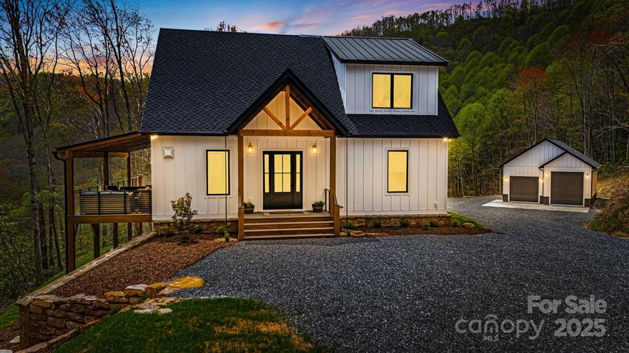 Experience refined mountain living and incredible vistas in this meticulous luxury farmhouse style home. The design and features elevate the concept of luxury living with its finishes creating a space that is both elegant and functional. Situated on 19.31 acres, the property offers year-round views, two additional home sites. There is a designated pathway easement from the community into Great Smoky Mountains National Park along the Cataloochee Divide. Enjoy a blend of luxury and warmth with custom Knotty Alder cabinetry, ZLINE DuraSnow appliances, leathered granite and quartz countertops. Delta Stryke fixtures in every bath and living space. Lower-level may function as separate living area with private entry, laundry, full bath, kitchenette. Windsor aluminum-clad, triple-pane hurricane impact windows  and doors, allow for storm protection and energy efficiency. A combination of Smart-home systems and high efficiency construction ensures comfort and security in a luxury mountain home.