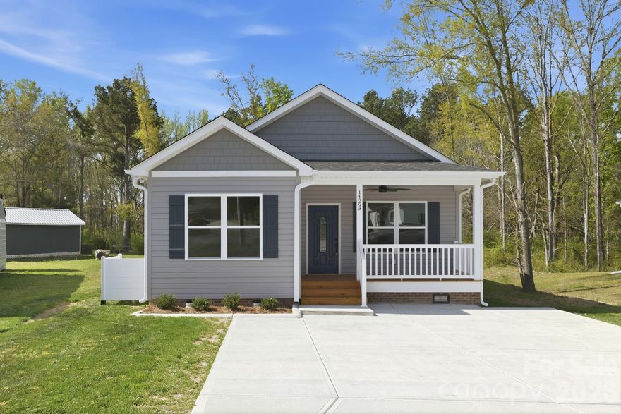 Welcome home to this beautiful new construction tucked away on a quiet cul-de-sac. This thoughtfully designed 3-bedroom, 2-full-bath home features an inviting open floor plan perfect for modern living and entertaining. The spacious living area is anchored by a cozy fireplace and accented with durable wood flooring throughout the main living spaces. The stylish kitchen offers stainless steel appliances, soft-close cabinetry, and seamless flow into the dining and living areas. Enjoy relaxing mornings on the charming rocking chair front porch and unwind in the evenings on the covered deck, complete with ceiling fans for year-round comfort. The primary suite boasts a generous walk-in closet and a private en-suite bath. Additional highlights include a large laundry room and quality finishes throughout. A perfect blend of comfort, craftsmanship, and contemporary style—this home is a must-see.