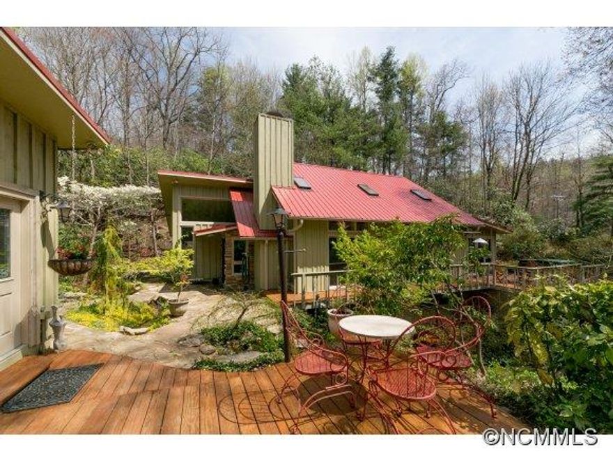 A Jewel of a Home in a magical "hollar".  5.25 acres w/ 3,056 sf under heat and a/c. Arts/craft style main hm has 2,056 sf w/soaring ceilings, lg windows, skylights & sliders filling the hm w/natural light, upscale kitchen & hdwd flrs. 2BR septic incl guest suite in LL.Sep guest/art studio has 1,000 sf, full bath, multi-use room, airy studio & kitchen, lwr lvl has lg htd shop/work space w/windows. South facing property-pond, springs & stream