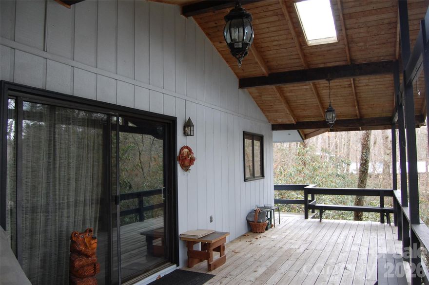 Treehouse set in the Rhododendron at Linville Land Harbor. Bring your plans to update this 80s home and make it your very own mountain retreat. Fabulous covered porch for enjoying your elevation! Parking area on Knoll Circle with steps down to the house. This generous lot in a homes only section of Land Harbor (NO RVs or Park Models) will allow for some expansion. Community has golf, pickleball, tennis, fishing, seasonal outdoor heated swimming pool and so much more. Summer finds Friday nights gathered at The Landing for live music. The Patio Grill is open from May to September offering a quick bit of lunch after enjoying a day at the pool or on the golf course. So much to do in this mountain resort community that you'll want to call it home year-round!