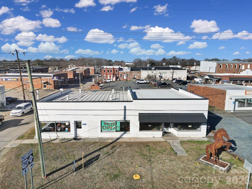 Iconic landmark commercial property located in the heart of downtown Marshville, NC. Widely recognized as the former home of Randy Travis, this is one of the most well-known buildings in Union County, offering unmatched visibility and brand recognition. 

Situated on a high-traffic corridor with approximately 30,000 vehicles per day, this property delivers exceptional exposure. 

A multi-million-dollar QT gas station is currently under construction directly across the street, further strengthening the commercial draw of this location. The building offers over 3,500 SF of retail or restaurant space on a large commercial footprint, ideal for a national or regional chain, restaurant, fast food concept, gas station, or other highway-oriented business. 

Additional opportunity through listing agent exists to purchase the adjacent parcel, creating an even larger assemblage next to Truist Bank. 

Rare chance to acquire a high-profile, high-traffic commercial asset in a rapidly developing corridor.