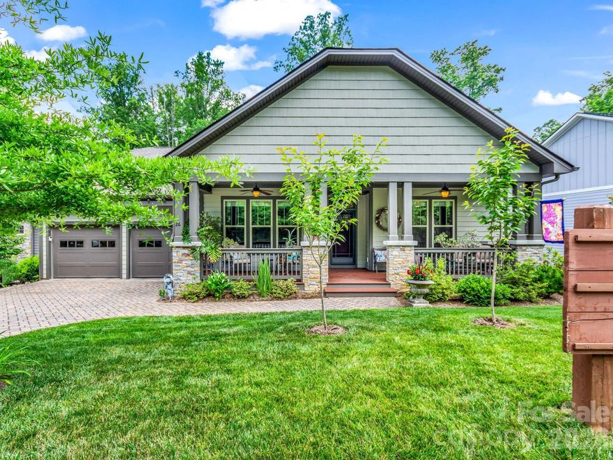 Experience the understated elegance of this immaculate Arts and Crafts home, ideally positioned within the highly sought-after Biltmore Lake community. A welcoming covered front porch opens into a thoughtfully designed interior where timeless craftsmanship blends seamlessly with modern comfort. The spacious great room features soaring ceilings, a floor-to-ceiling stone fireplace, and custom Amish-built cabinetry, creating a warm and inviting centerpiece for daily living and entertaining alike. The open-concept layout flows naturally into a bright kitchen appointed with granite countertops, marble backsplash, and a generous walk-in pantry • Highlights include a main-level primary suite overlooking the natural beauty of Scott’s Mountain and Bill Moore Creek, featuring double vanities, a walk-in shower with sky-view window, and a spacious walk-in closet. The fully finished lower level offers exceptional flexibility with a secondary living area, guest bedroom, full bath, and dedicated storage space • Outdoor living is equally inviting, with professionally landscaped and irrigated grounds along with dual-level decking overlooking the private backyard setting. One of the unique advantages of this location is its immediate proximity to Biltmore Lake’s extensive trail system, with trail access located just a short distance down the street providing convenient pedestrian access to the lake, clubhouse, tennis courts, pickleball courts, and other community amenities without the need to drive • Residents of Biltmore Lake enjoy a lifestyle centered around a 62-acre lake with private beach access, miles of hiking and biking trails, tennis and pickleball courts, playgrounds, and a vibrant clubhouse and bandstand hosting seasonal events and concerts. For added peace of mind, the seller has commissioned a comprehensive pre-listing inspection available for review by qualified buyers, and a Home Warranty is included. Home is vacant, easy to show, and ready for immediate enjoyment.
