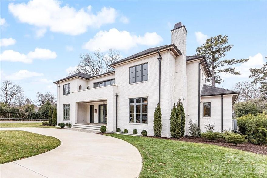 Located in the heart of Myers Park across from Freedom Park, this exceptional full-brick residence offers over 7,000 square feet of refined living space on a beautifully positioned 0.46-acre corner lot. Built in 2024, the home blends timeless architecture with thoughtfully designed modern comfort. The main level features expansive living and entertaining spaces, including a gracious dining room, elegant living areas, and a chef’s kitchen outfitted with premium appliances including a gas cooktop, beverage refrigerator, ice maker, tankless water heater, and more. A main-level primary suite provides convenience and privacy, complemented by a luxurious en-suite bath. An additional main-level bedroom offers flexibility for guests or office space. Upstairs, you’ll find four spacious bedrooms, multiple full baths, a bonus room, flexible living space, and additional laundry access, creating ideal separation and functionality for everyday living. Outdoor living is equally impressive with a heated in-ground pool and spa, in-ground hot tub, irrigation system, and a private fenced backyard designed for relaxation and entertaining. The circular driveway and side-facing three-car attached garage provide both convenience and striking curb appeal. Situated within close proximity to Dilworth, Sedgefield, and all that Myers Park has to offer, this home delivers luxury, location, and lifestyle in one of Charlotte’s most sought-after neighborhoods.