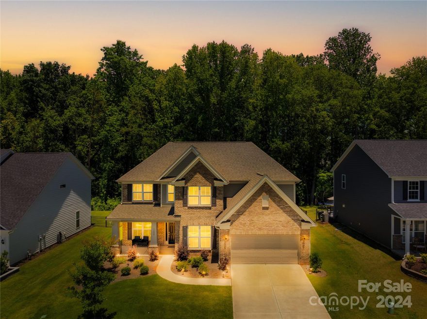 Welcome to 1200 Regions Blvd, a stunning 2022 build, brick-front home in the gated community of Bretagne. This spacious property offers top-rated schools, a clubhouse with a pool, and a large lot backing up to the woods for ultimate privacy. The main level features a primary suite with a walk-in closet, a soaking tub, and a waterfall shower. The cozy living room has a brick fireplace and large windows. The gourmet kitchen boasts white cabinets, quartz countertops, a butler's pantry, and an additional pantry. Enjoy the sunroom and private concrete patio. The main level also includes an office and an extra office area off the living room. Upstairs, you'll find a large open loft, two bedrooms with a Jack and Jill bathroom, a third bedroom with a private bathroom, and all bedrooms with walk-in closets. Additional features include ample walk-in attic storage and easy access to luxurious amenities. The 3 car tandem garage has been fully finished complete with epoxy floors!