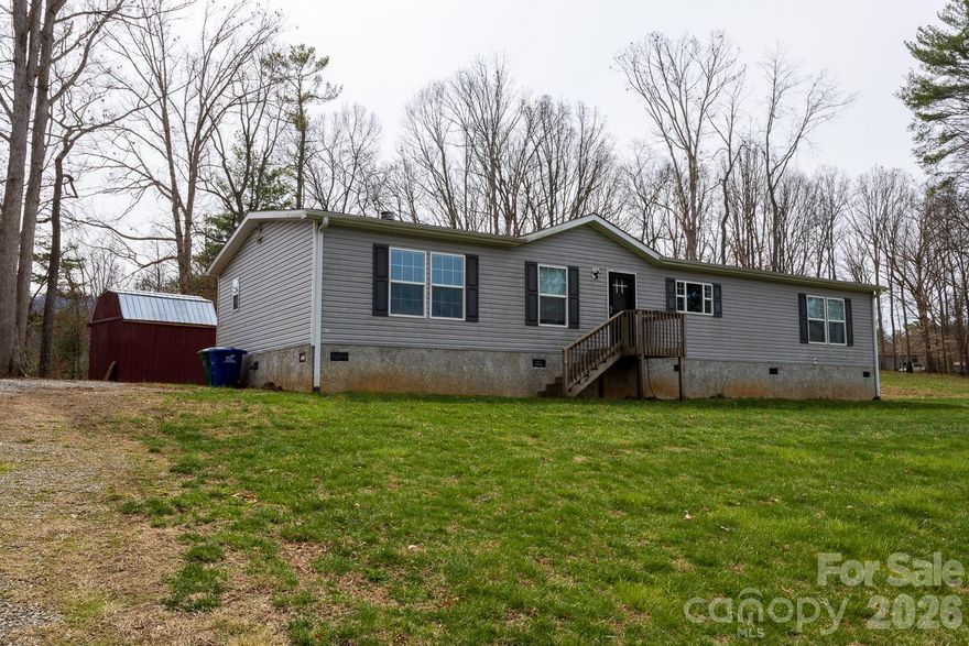 Come enjoy peaceful country living at 967 Barnardsville Highway! This well-maintained 2018 manufactured home sits on 1.97 acres, offering both space and serenity just outside of town. The home has been thoughtfully improved and is in great condition, making it truly move-in ready.
You’ll be able to have an evening unwind with beautiful long-range views across rural Barnardsville and the surrounding mountains. The property provides a perfect blend of open space and privacy, ideal for gardening, relaxing, or simply taking in the scenery.
A handy outdoor shed adds valuable storage for tools, equipment, or hobby space. Whether you're looking for a full-time residence or a quiet retreat, this property delivers comfort, views, and room to breathe.