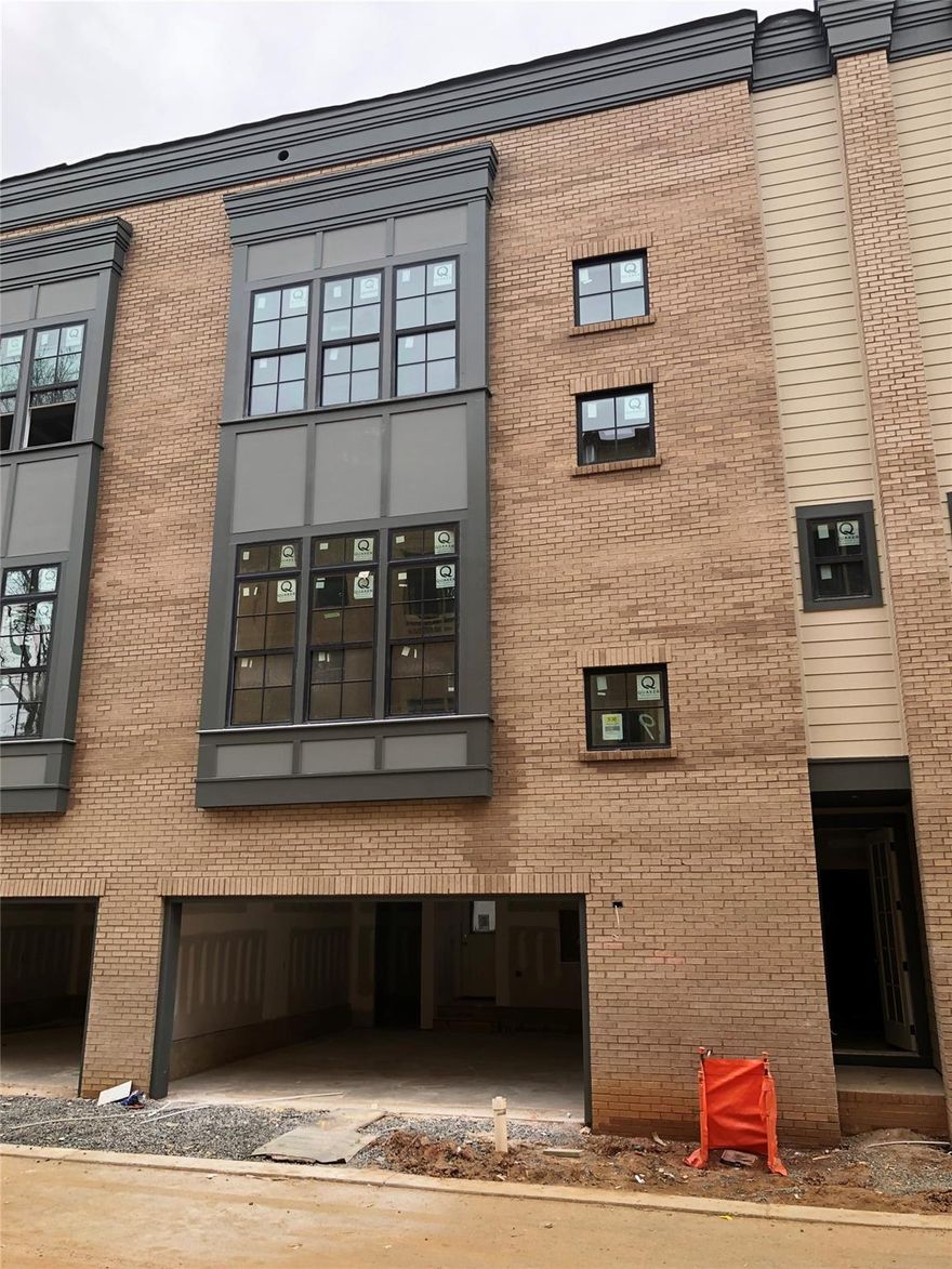 NEW CONSTRUCTION! Charming brownstone style townhome in the heart of Madison Park. Large windows throughout for lots of natural light. Find a 2 car side by side garage on the first level along with a bedroom suite with a covered patio. The main level features open living spaces and a large central island in the kitchen. The statement steel railing stairs to the third level bring you to a spacious primary suite, another bedroom with it's own bath and a large laundry room with shelving for storage. Premium finishes include engineered vinyl plant floors, gas range with chimney hood, quartz countertops and stacked shaker style soft close cabinets in the kitchen. Primary suite features large walk in closet and luxurious primary bath with separate water closet, dual sink vanity, upgraded tile floors, tile shower floor & surround (to the ceiling). Small community of only 18 townhomes - don't miss your chance to live in a great convenient location!