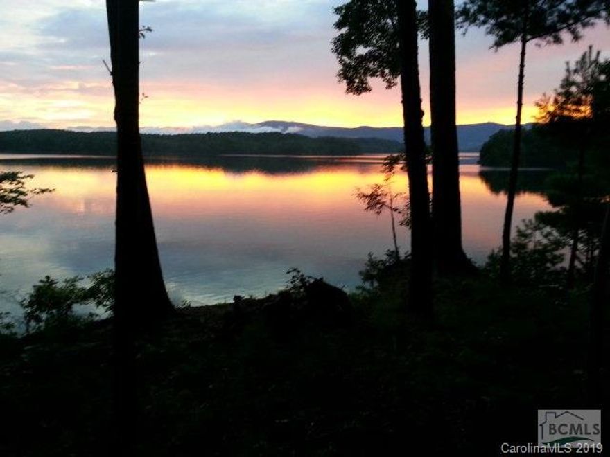 Open the private gate and continue down the tree-lined drive for several hundred yards before you even get a glimpse of this beautiful waterfront cabin.  With water on three sides and the best view available on Lake James, these 9+ acres are irreplaceable.  Watch the sunset over Mt. Mitchell and Dobsons Knob from your porch.  Look directly into the Linville Gorge with miles of water in front of you.  The post and exposed beam home feels warm and cozy while offering room for the whole family and more with 5 bedrooms and 3.5 baths.  Features inside the house include Caribbean pine floors, Brazilian rosewood decking. An additional full bath is plumbed beside the 3rd floor game room.  Want more?  Build 3 more dwellings on this lot, if youd like.  The septic system is designed to accommodate 12 bedrooms!  An easy walking path, high-quality dock, and shoreline stabilization are already in place at the shoreline. Want to see your closest neighbor? Check out our drone video!