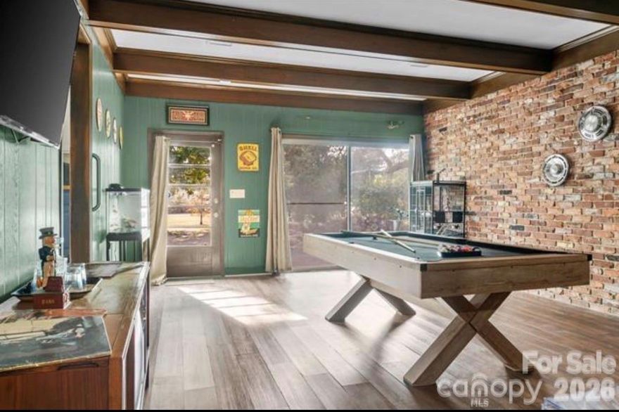 Welcome to 511 Marlboro St NE, a charming 3 bedroom, 2.5 bathroom brick home situated on a desirable corner lot near downtown. This home offers character, functional space, and thoughtful updates throughout. The living room features a large front window that fills the home with natural light along with a cozy wood burning fireplace, creating a warm and inviting atmosphere. The kitchen showcases butcher block countertops and flows easily into the main living areas, making it ideal for everyday living and entertaining. A tankless water heater provides added energy efficiency and modern convenience. The spacious bonus billiard and game room offers flexible use as a second living area, recreation space, home office, or gym. Outdoor features include a welcoming front porch, wrap around driveway, detached garage, and ample yard space. Enjoy convenient access to downtown Aiken, local dining, boutique shopping, Hopelands Gardens, Hitchcock Woods, the Aiken Farmers Market, and popular community events. A great opportunity to own a home that blends charm, space, and location.