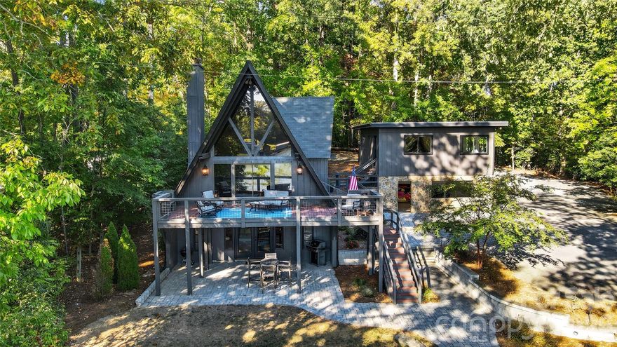 Peaceful waterfront home nestled on a wooded lot on Lake Wylie with private boat ramp and floating TREX dock. Timeless A Frame home offers year round living with the charm of a vacation lifestyle. You’ll love the open floor plan, exposed wood beams, beautiful wood flooring, and soaring windows. The Light filled Great room has vaulted ceiling and stone wood burning fireplace with access to the outdoor living area. Updated Kitchen with quartz counters, SS appliances, breakfast bar, and pantry. Upper level provides bedroom, half bath and loft, perfect as office or second living area. Spacious bedroom and full bath complete main level. Lower level offers recreation area with wet bar and fireplace, plus 2 bedrooms and full bath.   Bonus/sunroom/ office space above the carport. Relax and enjoy the serene atmosphere & beautiful views from the comfort of your back deck, entertain and grill out on your covered patio or lake side deck, and enjoy the resort style amenities of the Palisades. Minutes away from shopping and dining, this beautiful property has all the convenience of living in the Palisades, with all the quiet and privacy of country lake living.