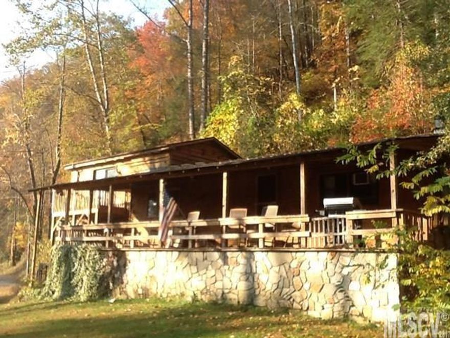 Rare opportunity to own approx. 242 feet frontage on beautiful Wilson Creek. This Unique property presently being used as Air B&B and sits on 3.52 acres with small waterfall, spring and pond. Rear of property adjoins National Forest lands. Beautiful views of the creek and surrounding area, not to mention all the outdoor activities like hiking, trout or fly fishing or kayaking right outside your front door. This three bedroom, two bath home has been remodeled in recent years and features a rustic but warm interior of mainly wood floors, walls and ceilings. Eat-in-kitchen features garden windows where you can hear the waterfall with fridge and new gas stove included. Relax on the huge front porch or have a picnic by the creek.