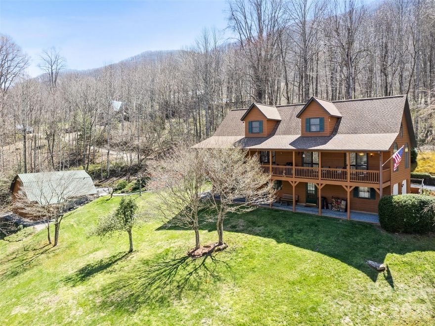 Two homes, a barn, mountain views, and the peaceful sounds of Johnson Branch Creek—all on 1.87 beautifully maintained acres. This unique mountain property offers flexibility, privacy, and income potential at approximately 3,300 feet in elevation, making it an ideal retreat to enjoy cooler summer temperatures. The main house features 3 bedrooms and 3.5 baths, highlighted by a dramatic two-story great room with tongue-and-groove wood ceilings, hardwood floors, and access to a full-length covered porch with hot tub. The kitchen offers convenient pass-throughs to the dining and living areas, and the main level also includes a large laundry room with pantry space, office area, and a spacious primary bedroom with ensuite bath. Upstairs, you'll find an additional bedroom, full bath, and large loft overlooking the great room. The lower level offers a walk-out apartment with covered deck, kitchen, full bath, and approximately 22x20 open living and sleeping area, along with a mudroom, utility room, and two-car garage. The charming, fully furnished Honeymoon Cabin (41 Stump Ln) provides additional living space or rental potential, featuring one bedroom, one bath with jacuzzi tub and shower, a sleeping loft, hardwood floors, wood-burning stove, and covered porch with hot tub and charcoal grill. Relax by the creek with a picnic table, park bench, and fire pit, all adding to the peaceful mountain setting. The cabin includes a Trane mini-split (2017), wall heaters, and a 2016 roof for year-round comfort. A two-story metal-roofed barn (27x27, 784 sq ft) with bathroom offers excellent space for hobbies, workshop, or storage, and there is also room to park an RV in either driveway. With short-term rentals allowed, multiple living spaces, and immaculate maintenance throughout, this rare property offers endless possibilities as a private mountain retreat, full-time residence, or investment opportunity.