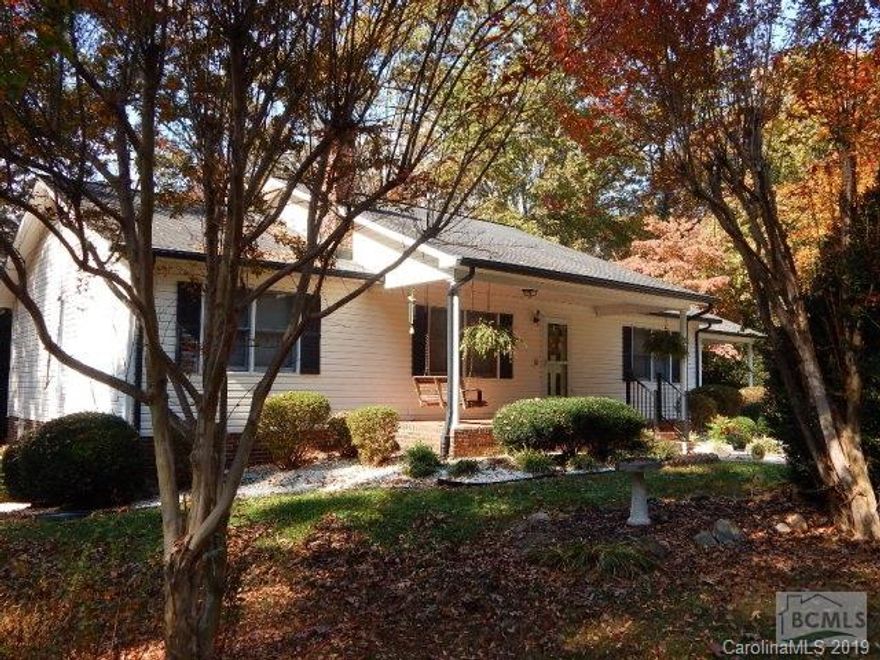 A Rare find! Over 6 private acres in town with a Stream that borders back property. The original owner has well maintained this home featuring 3 BR/2 BA with a unfinished partial basement, Attached DBL Carport, Manicured/mature landscaping with wooded views. One level living floor plan with everything you need. A covered brick entry opens to a large spacious living room w/natural gas fireplace. Entertaining kitchen & dining area w/ample Oak cabinetry, all appliances included. True Master ensuite, Dbl vanity, shower tub, His & Hers WICs plus a third for linen. Split floor plan with 2 additional generous bedrooms and 2nd full bath. Large laundry room. Rear of home with screened covered breezeway to attached 12'X 24 heated/cooled Bonus/Workshop/Office area. Basement with 2 separate entries for additional Storage or workshops. Rear yard with back deck & Rocked landscaped walkway,back of property borded by a stream, 17'x26' Patio area, 12'x26' Outbuilding. Seller offering One Year Home Warr